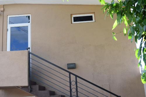 a door on a building with a staircase at Baywatch Apartment in La Gaulette