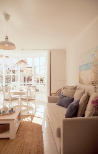 a living room with a couch and a table at Balili Beach House in Ferrel