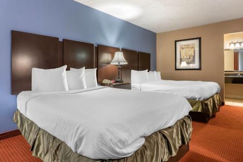 Ένα ή περισσότερα κρεβάτια σε δωμάτιο στο Dutchland Motel