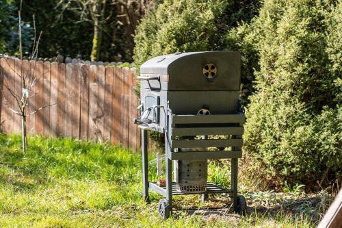 a grill sitting in the grass in a yard at Ferienwohnung Eichenhof in Blankensee