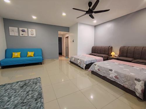 a bedroom with two beds and a ceiling fan at Loveu homestay 232 duyung in Seremban