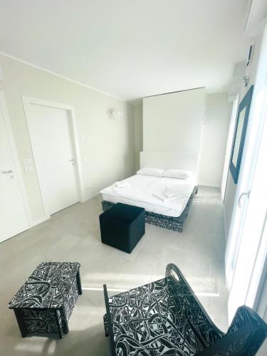 a room with two beds and two chairs in it at Antica Osteria sant Andrea in Misinto