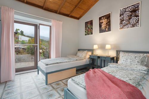 a bedroom with two beds and a window at Casa del Cielo in Adeje