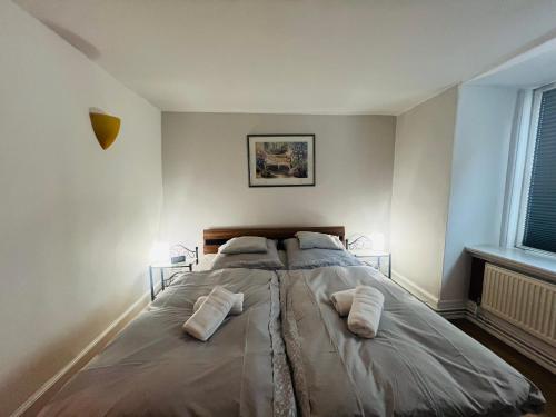 a bedroom with a large bed with two pillows on it at Elvis Family Dream in Lübeck