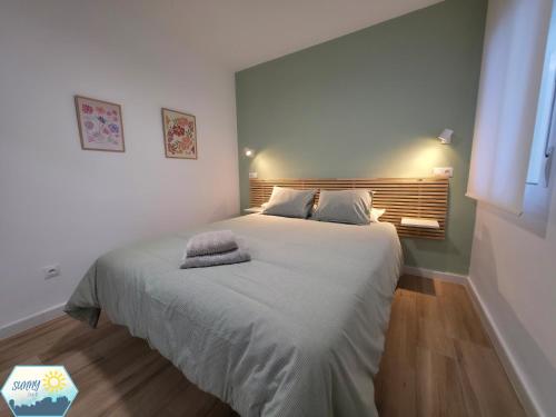 a bedroom with a large bed with two pillows on it at Sunny Churriana City in Málaga