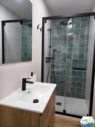 a bathroom with a sink and a shower at Sunny Churriana City in Málaga