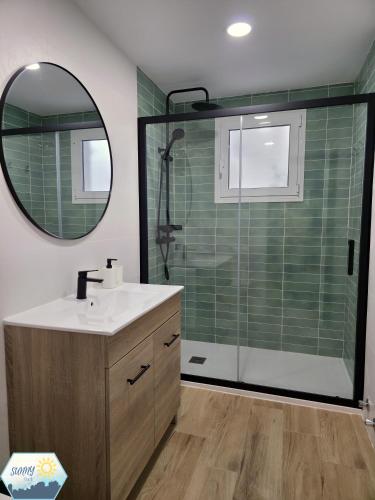 a bathroom with a sink and a shower with a mirror at Sunny Churriana City in Málaga