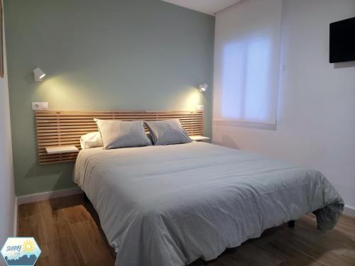 a bedroom with a large bed and a television at Sunny Churriana City in Málaga