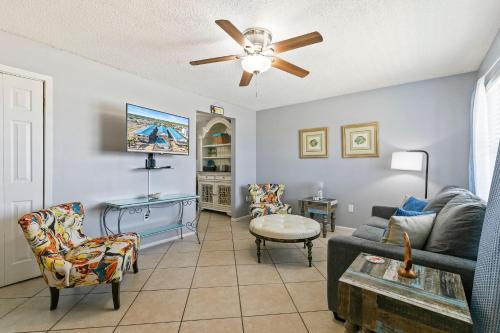 a living room with a couch and a ceiling fan at 2BR Condo w Pool Beach Access and Walk to Hangout in Gulf Shores