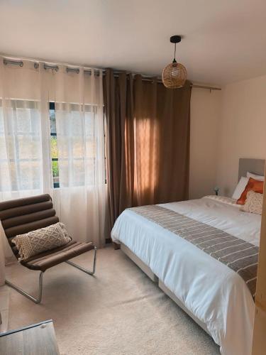 a bedroom with a bed and a chair and a window at Dani House - Porto Moniz Escape in Porto Moniz