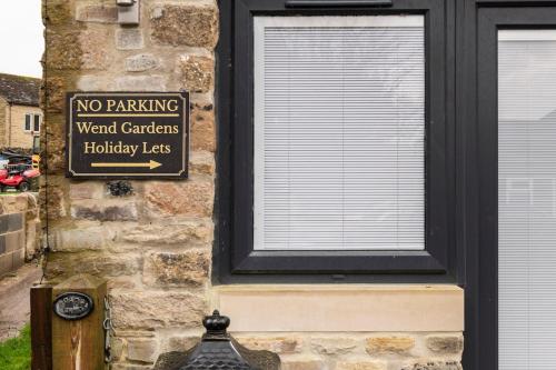 a no parking sign on the side of a building at Wend Gardens Studio Carleton Skipton Pet Friendly in Skipton