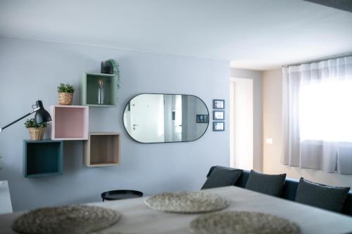 a dining room with a table and a mirror at MiMa Loft in Milano Marittima