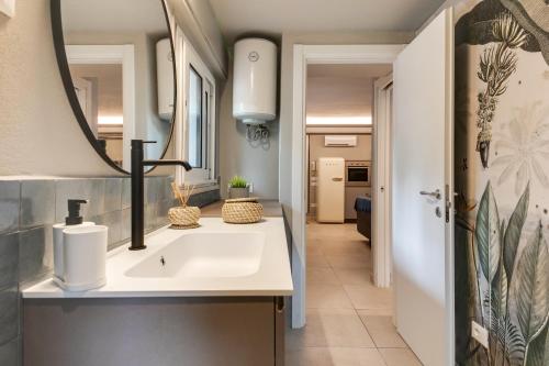 a bathroom with a sink and a mirror at MiMa Loft in Milano Marittima