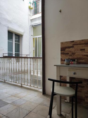 a table and a chair on a balcony at Old Merchant's Home in Cádiz