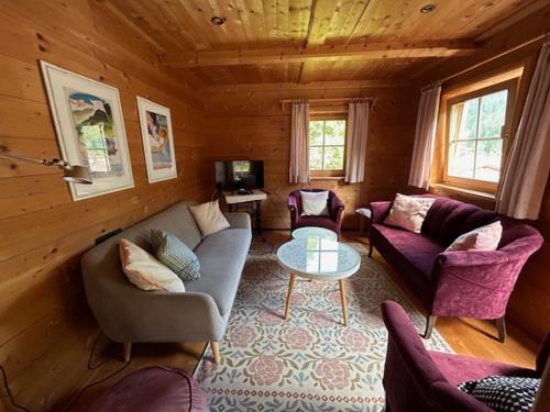 a living room with a couch and chairs and a table at Bauernhaus Spathen in Santa Valburga St. Walburg