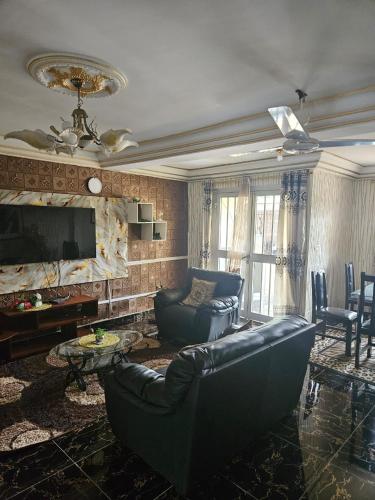 a living room with a couch and a tv at Rose Garden Apartments in Limbe