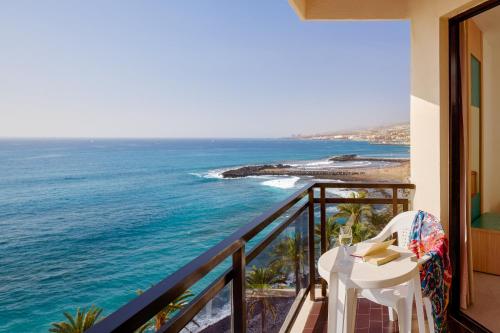 a balcony with a table and a view of the ocean at Sol Tenerife in Playa de las Americas