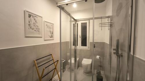 a bathroom with a glass shower with a toilet at Blu Eracleo in Trapani