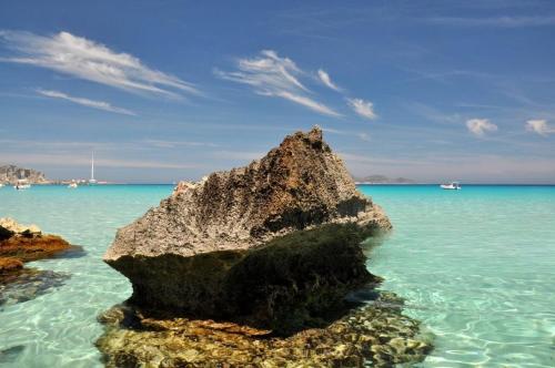 a rock in the water on a beach at Blu Eracleo in Trapani