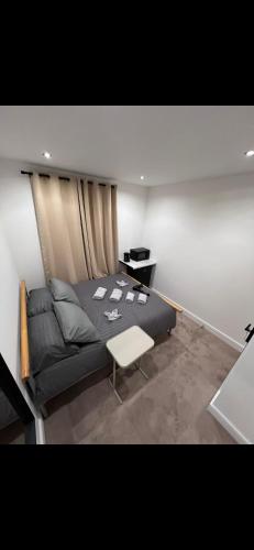 a bedroom with a black bed and a table at Room in Central London Zone 1 in London
