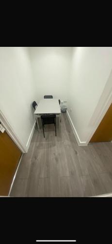 a white room with a table and a bench at Room in Central London Zone 1 in London
