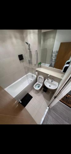 a bathroom with a toilet and a sink and a bath tub at Room in Central London Zone 1 in London
