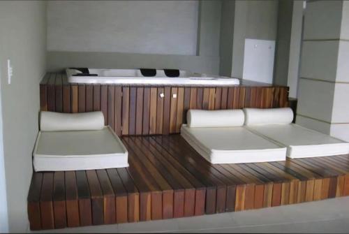 a room with two beds on a wooden deck at Apartamento Bela Vista Porto Real Resort in Mangaratiba