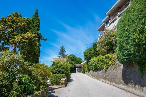 an empty street with trees on the side of a building at Residenz La Selva Studio-Apartments in Ghiffa