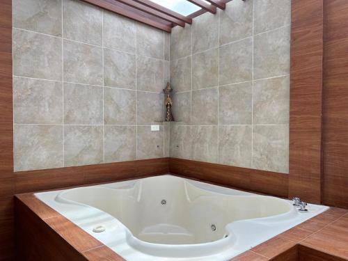 a bathroom with a large tub in a room at Luxury Villa with Jacuzzi 4 Bedroom 4 Bath in Baños
