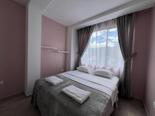 a bedroom with a bed with two towels on it at Luxury Villa with Jacuzzi 4 Bedroom 4 Bath in Baños