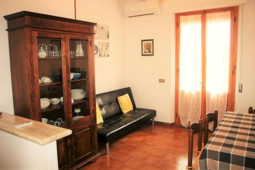 a living room with a chair and a cabinet at Podere Olmo Adriano in Sovicille
