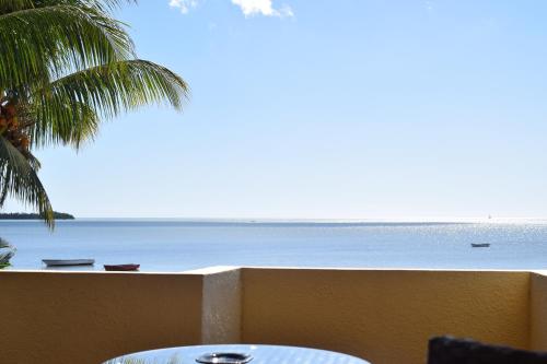 a view of the beach from the balcony of a resort at Baywatch Apartment in La Gaulette