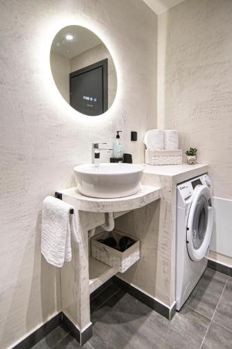 a bathroom with a sink and a washing machine at Flats Avenue 236 - C in Alexandroupoli