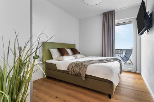 Postel nebo postele na pokoji v ubytování Ocean Harbour- 2 OG, Balkon, Kamin