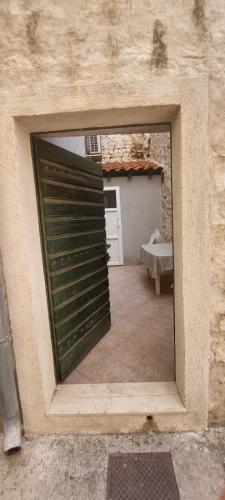 a large door in a building with a garage at Torriano Holiday House in Šibenik