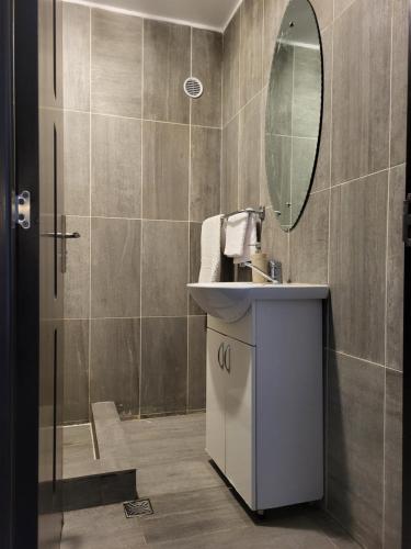 a bathroom with a sink and a mirror at Penthouse Marasti in Cluj-Napoca