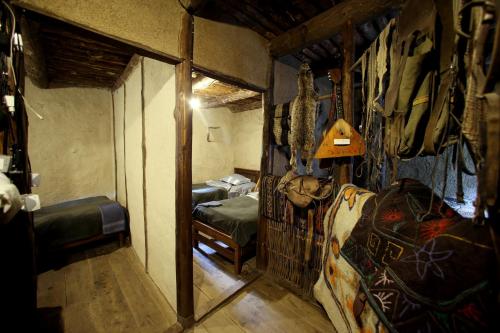a small room with two beds and a room with a room at Fortress House Andaqi in Shatili