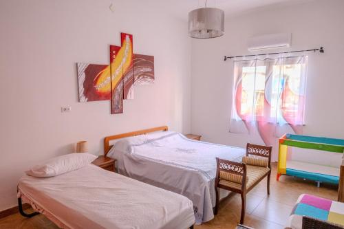 a hospital room with two beds and two chairs at Casa Vacanza - Apri il Cancello e Sei in Acqua in Vibo Valentia Marina