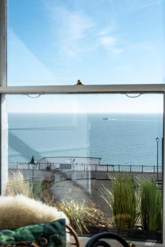 a view of the ocean from a window at The Wellington - style, charm and sea views in Ramsgate