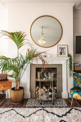 a living room with a fireplace and a large mirror at The Wellington - style, charm and sea views in Ramsgate