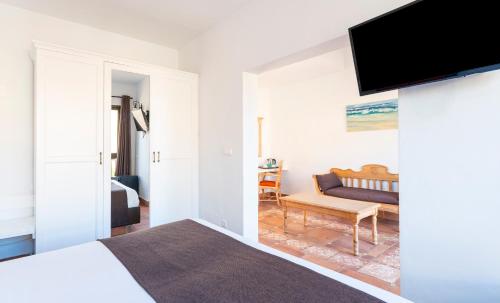 a bedroom with a bed and a tv on a wall at Bakour Fuerteventura La Pared in La Pared