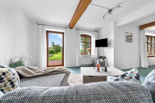 a living room with a couch and a table at Landhaus Hohe Luft in Steinberg