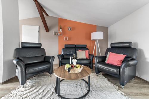a living room with two chairs and a table at Landhaus Hohe Luft in Steinberg