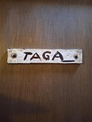 a sign on a wooden door with the word racism at Cal Tonico Rural in Ribes de Freser
