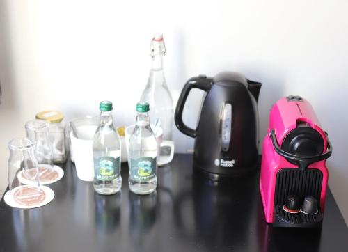 a black counter with bottles of water and a blender at Ashes Seafood Restaurant Accommodation in Dingle