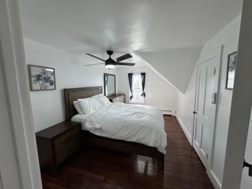 a bedroom with a bed and a ceiling fan at The Captains Perch in Stonington