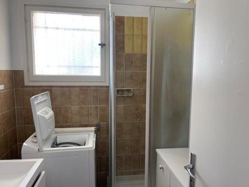 une salle de bain avec douche et toilettes et une fenêtre dans l'établissement T2- Piscine- Plages- Commerces, au Lavandou