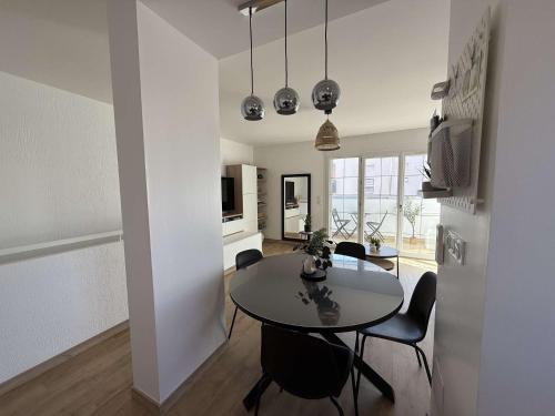 une cuisine et une salle à manger avec une table et des chaises dans l'établissement T3- Rénové- Clim- Plages- Commerces, au Lavandou
