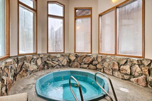a jacuzzi tub in a room with windows at Hot Tub Access Bright Breckenridge Condo in Breckenridge