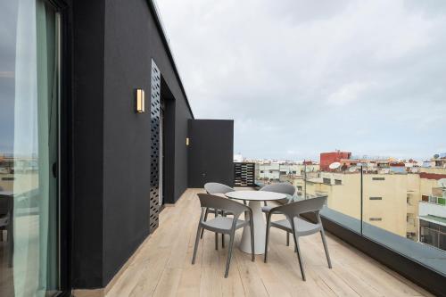 a room with a table and chairs on a balcony at Eurostars Casa Anfa in Casablanca